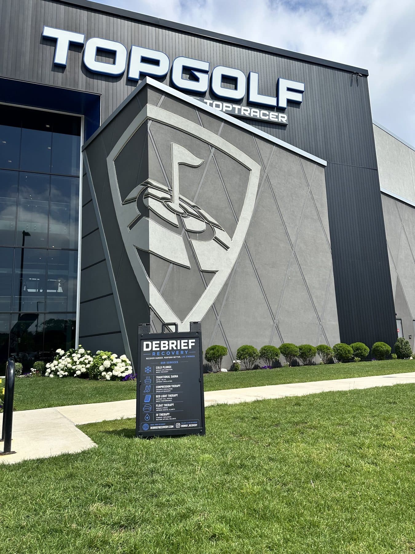 Debrief Recovery corporate event setup at Topgolf